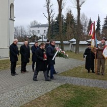 Powiększ zdjęcie Starosta Dariusz Czechowski składa kwiaty przy symbolicznej mogile dowódców AK gen. S. Roweckiego i gen. L. Okulickiego, przy Kościele pw. Wniebowzięcia NMP we Włoszczowie. Po lewej Członek Zarządu Rafał Pacanowski trzyma znicz.
